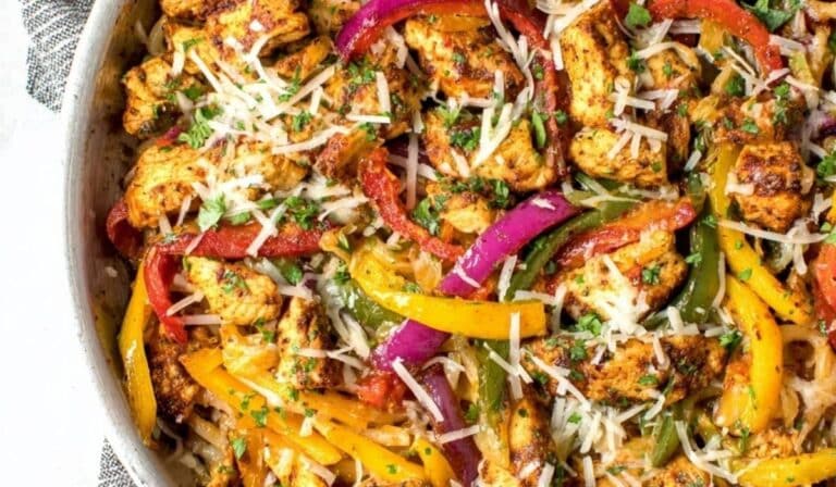 30 Minute Sheet Pan Chicken Fajitas with colorful peppers and onions on sheet pan