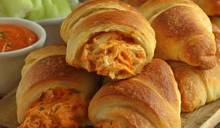 Buffalo Chicken Crescent Rolls on a white plate with dipping sauce