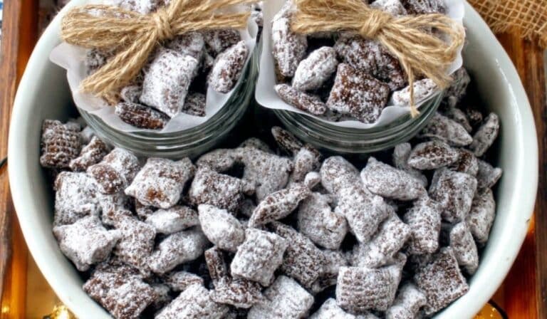 Puppy Chow Chex Mix in a rustic bowl on wooden table