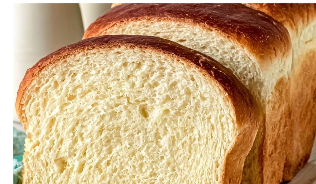 Freshly baked soft Amish white bread on wooden board in farmhouse kitchen