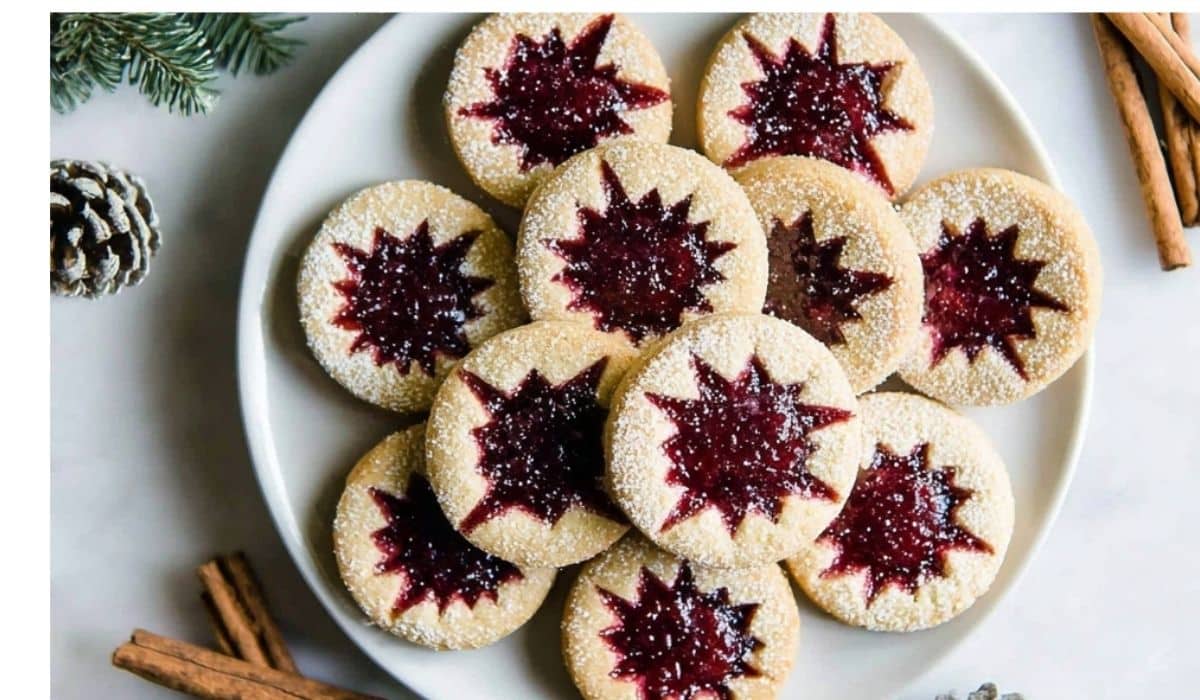 Raspberry Linzer Cookies on rustic holiday table