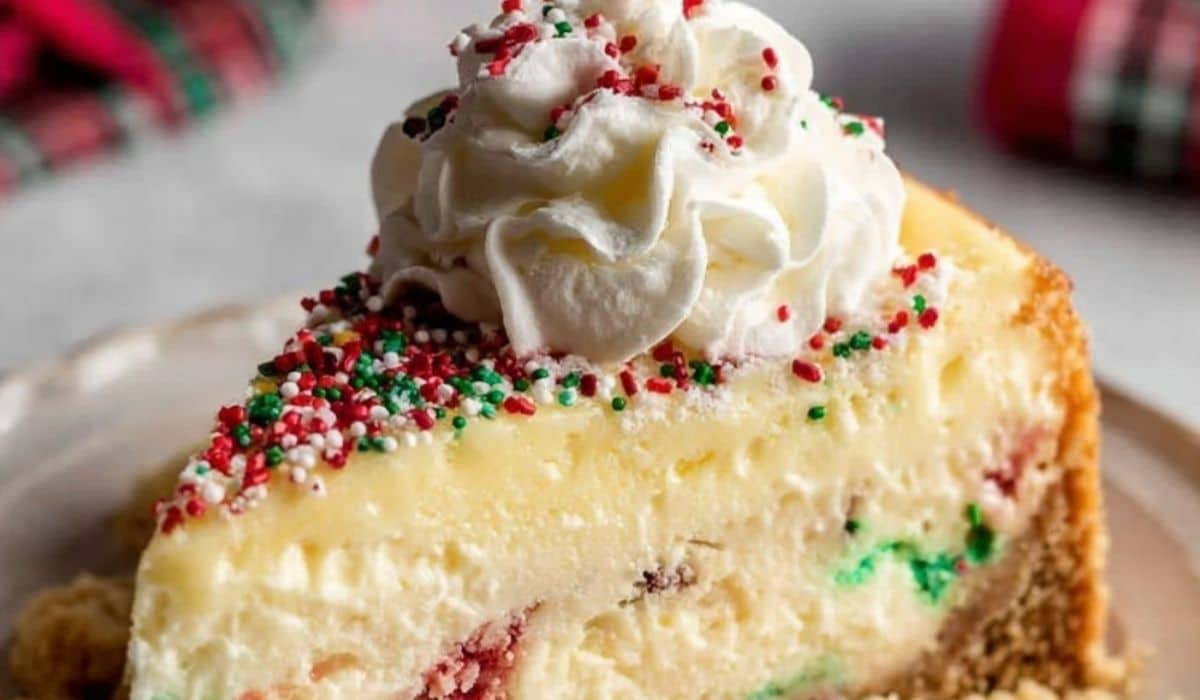 Sugar cookie cheesecake with whipped cream and holiday sprinkles