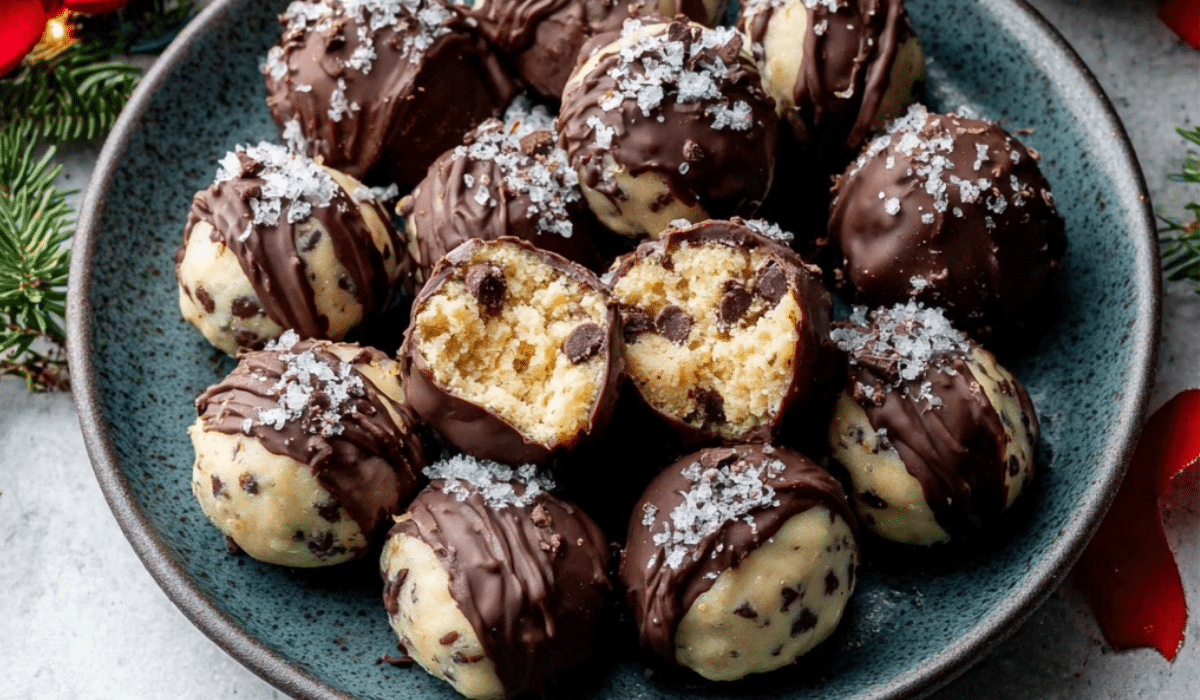 Cookie Dough Truffles on marble surface with chocolate drizzle
