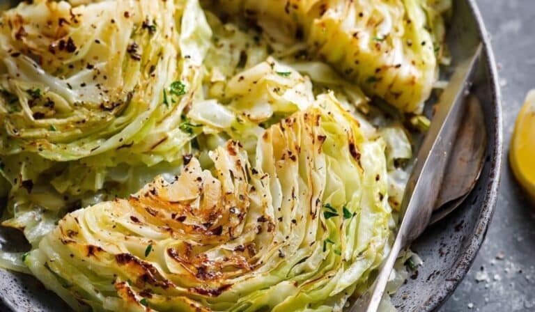 Simple sautéed green cabbage with golden edges in a cast-iron skillet